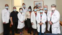 Nine members of the pulmonary diagnostics care team stand together